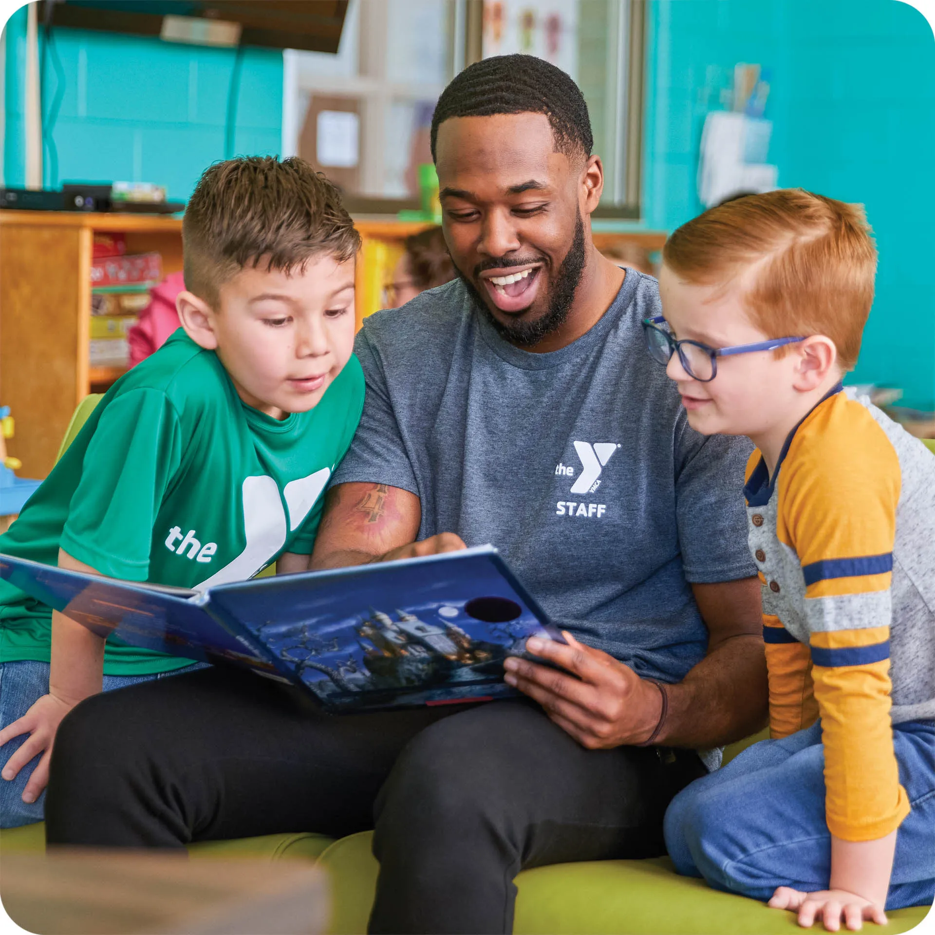 Y staff reading to kids after school