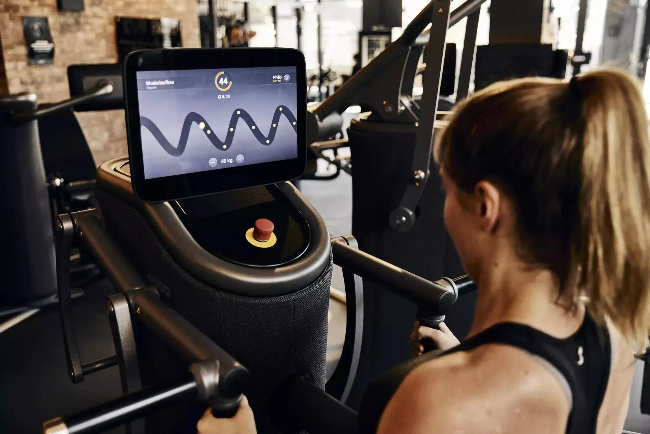 Woman standing at YMCA EGYM machine
