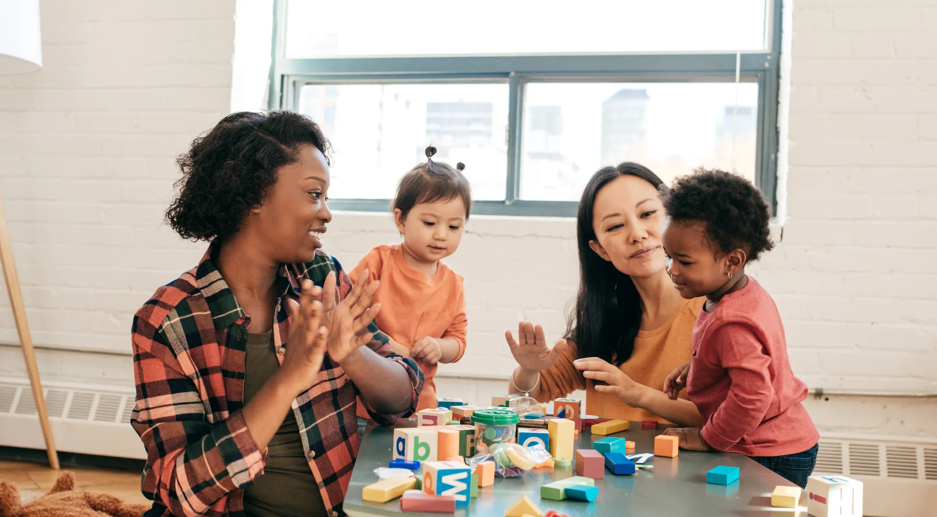 Parents playing with toddlers and preschoolers at YMCA program