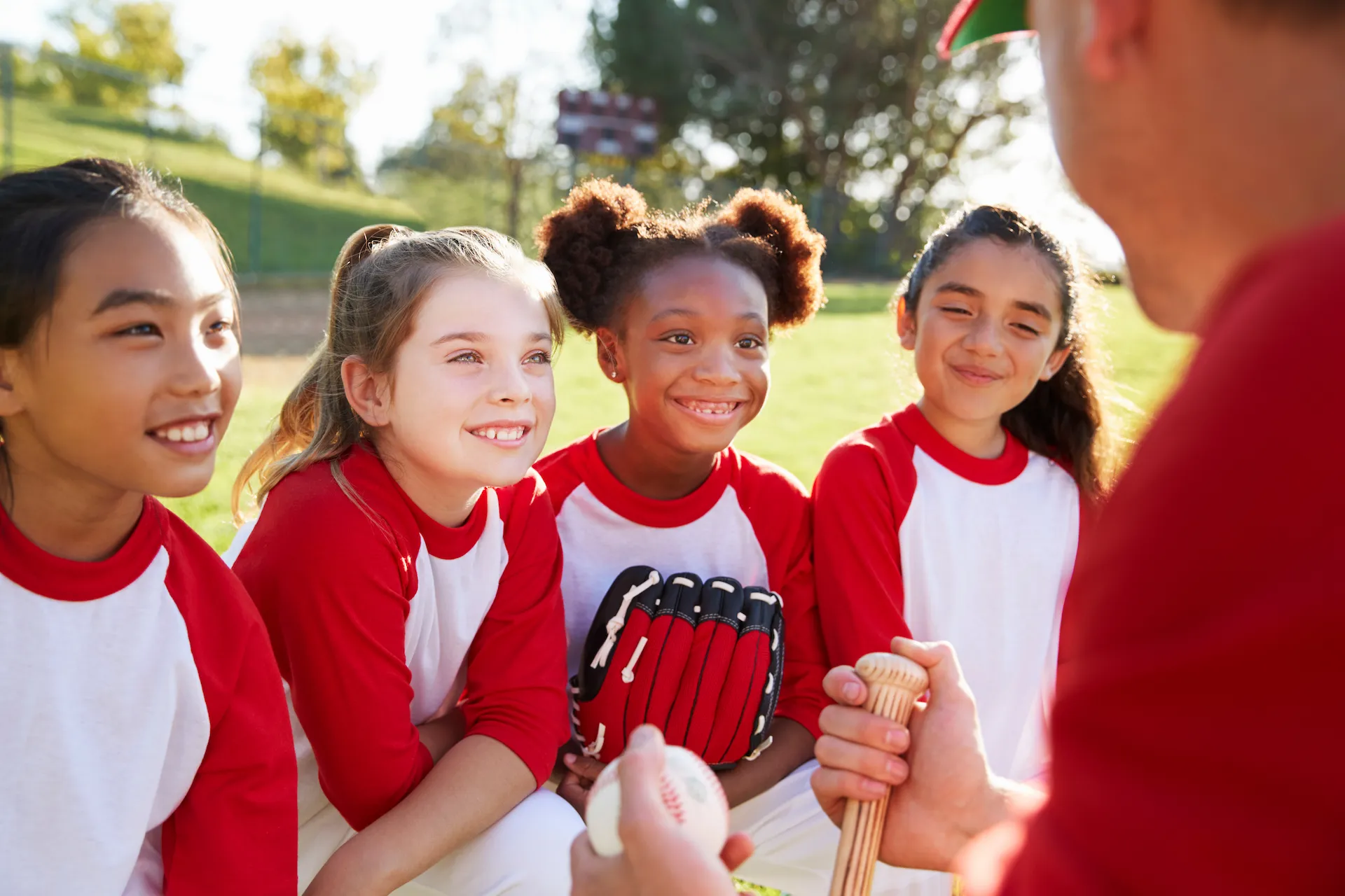 YMCA Softball players talk to their coach